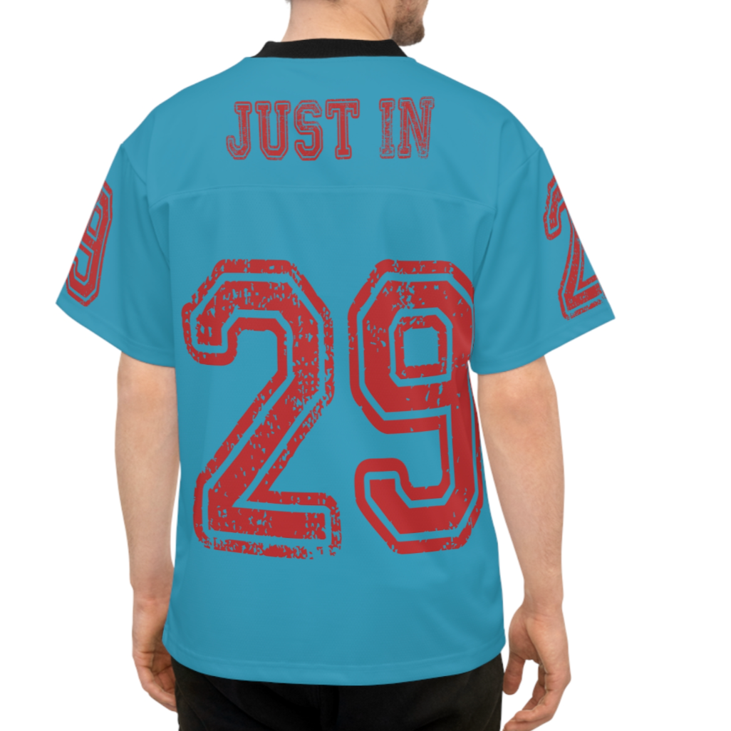 Man wearing a blue t-shirt with red text and numbers on the back